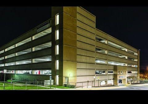 Reston Hospital Center’s parking structure from outside at night, shining brightly with LED parking garage lighting.